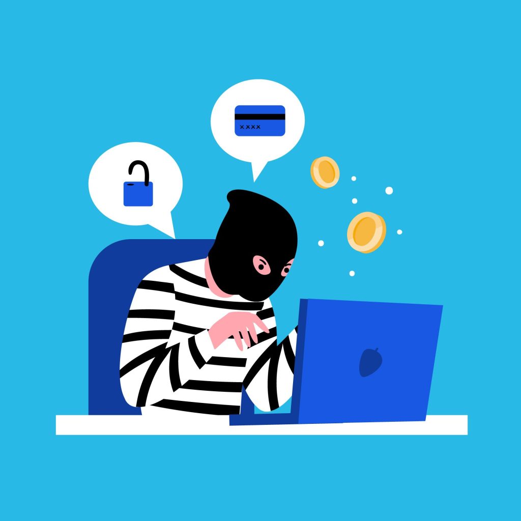 A man wearing a mask sits at a desk working on a laptop while attempting to commit financial fraud